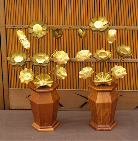 #Y111  Pair of gilt bronze lotuses (loti) in six-sided hardwood vases. Each celestial bunch consisting of nine gilt etched leaves, flowers, buds