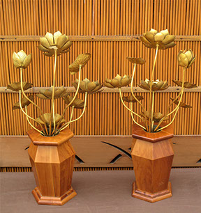 #Y111  Pair of gilt bronze lotuses (loti) in six-sided hardwood vases. Each celestial bunch consisting of nine gilt etched leaves, flowers, buds